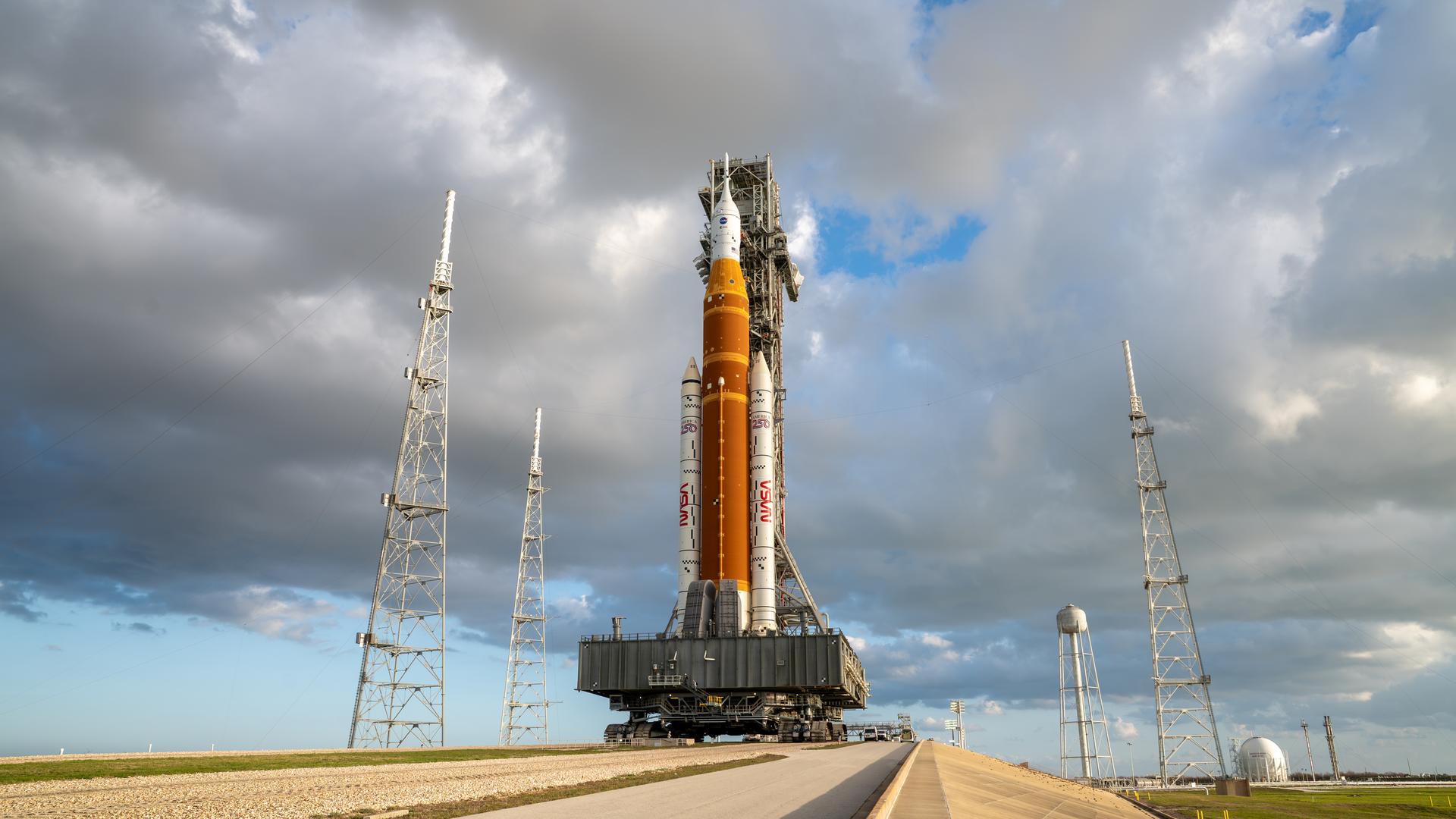 This image shows NASA’s SLS (Space Launch System) and Orion spacecraft rolling out of the Vehicle Assembly Building at NASA’s Kennedy Space Center. NASA's massive Crawler-Transporter, upgraded for the Artemis program, carries the powerful SLS rocket and Orion spacecraft on the Mobile Launcher from the Vehicle Assembly Building to Launch Pad 39B at Kennedy Space Center in preparation for the Artemis II mission. 